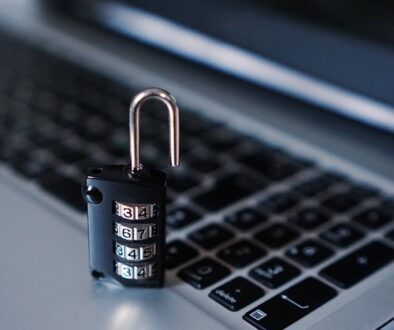 An unlocked secure lock on a laptop illustrating a hacked email account and AFSL compliance obligations.