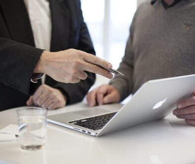 A financial adviser explaining a Financial Services Guide to a client in a professional setting